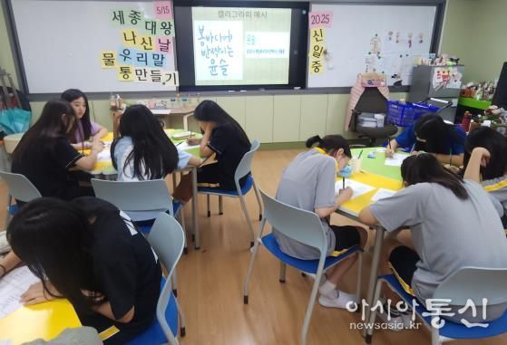 신일중학교 학생들이 세종대왕 탄신일을 맞아 한글 멋 글씨로 꾸민 물통을 제작하고 있다
